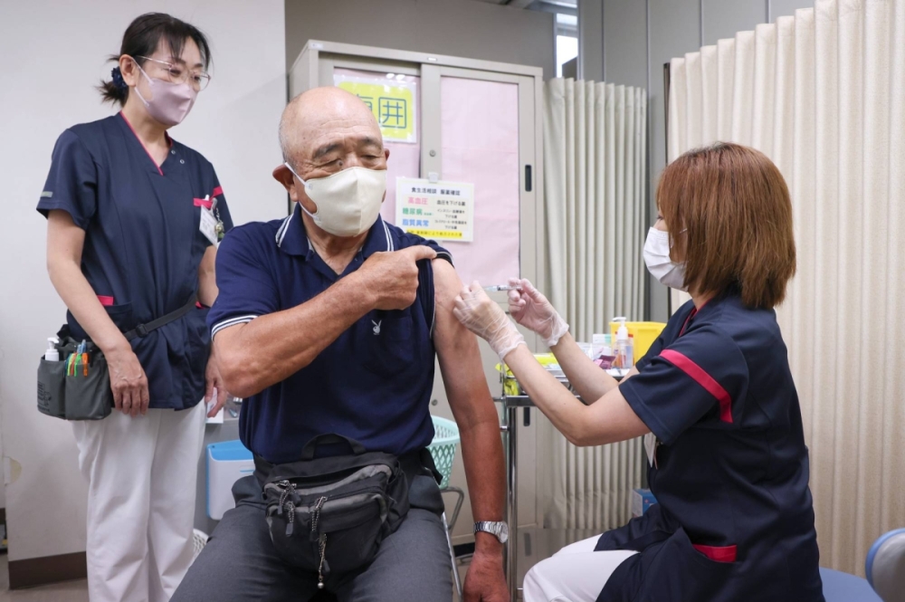 Experts move to allay replicon COVID shot fears in Japan amid backlash