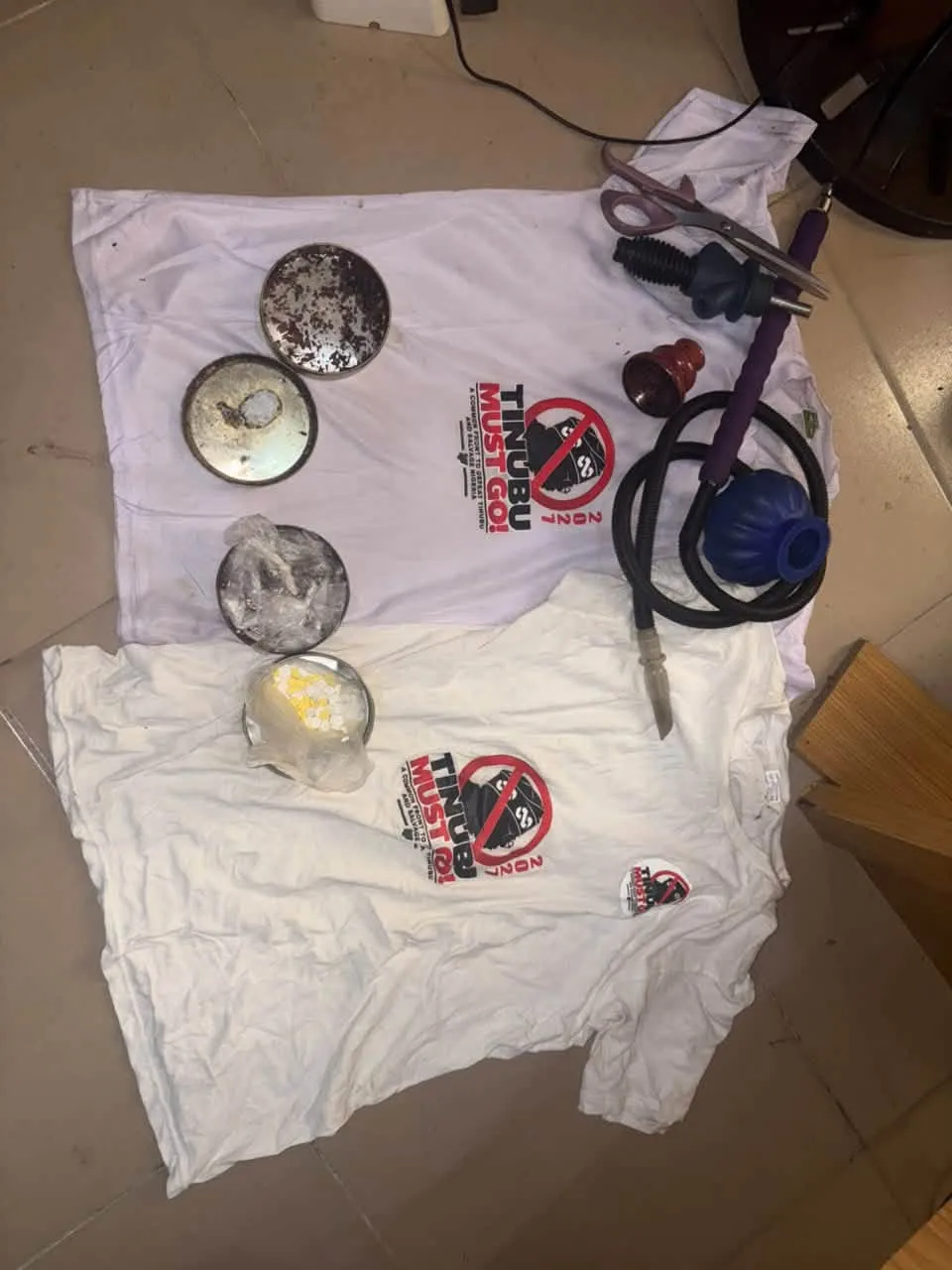 ‘Tinubu Must Go’ Shirts: Amnesty Rejects Police Drug Claim, Demands Release of Five Men